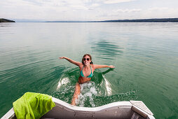 Young woman bathing in lake Starnberg, Bavaria, Germany