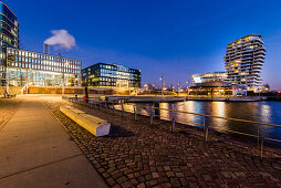 Modern architecture in the twilight, Am Kaiserkai, view to the Grasbrook harbour and Marco-Polo-Tower in the HafenCity, Hamburg, Germany