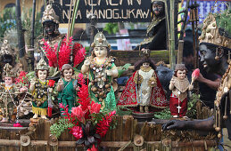 Black faced man with holy statuettes and dolls, Ati Atihan Festival, Kalibo, Aklan, Western Visayas Region, Panay Island, Philippines