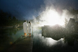 Hotel guests on a jetty at a natural source pond, Tannheim, Tannheim Valley, Tyrol, Austria