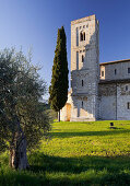 Sant Antimo Abbey with cypress and olive trees, Castel Dellabate, Tuscany, Italy