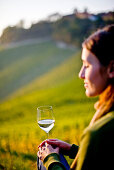 Young woman holding a glass of white wine, Spielfeld, Styria, Austria