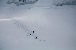 Group of skier downhill skiing on glacier Durand to Val d Anniviers, Canton of Valais, Schwitzerland