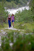 Two female hikers walking the Alpe-Adria-Trail, Nockberge, Carinthia, Austria