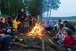 Campfire at campground at lake Ellbogensee, Mecklenburg Lake District, Mecklenburg-Western Pomerania, Germany