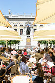 Pavement cafe, old stock exchange building in background, Leipzig, Saxony, Germany