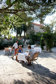 Guests in a restaurant on the Piazza, Aman Sveti Stefan, Sveti Stefan, Budva, Montenegro