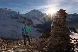 Female hiker looking at view in Val Bernina, Piz Palu and Pers Glacier in background, Engadin, Canton of Grisons, Switzerland