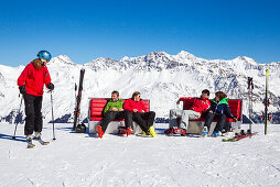 Skiers resting on a sunboxes beside a ski slope, Lavoz, Lenzerheide, Canton of Graubuenden, Switzerland