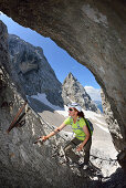 Woman ascending on fixed rope route to Zugspitze, Wetterstein mountain range, Upper Bavaria, Bavaria, Germany
