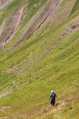 Hiker walking down from Bisaurín peak 2 676 m  Aragües valley  Aragües del Puerto, Aragón  Spain