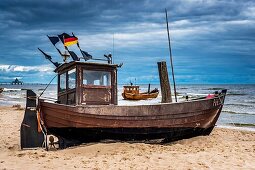 Two Fishing boats at the beach of the Baltic Sea, near the pier of the Baltic Sea resort of Ahlbeck, Municipality of Heringsdorf, Usedom Island, County Vorpommern-Greifswald, Mecklenburg-Western Pomerania, Germany, Europe