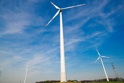 Wind turbines and electricity pylons, Dortmund, North Rhine-Westphalia, Germany