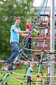 Father and son (7 years) on a climbing frame, Styria, Austria