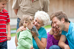 Großfamilie streichelt ein Kaninchen, Steiermark, Österreich