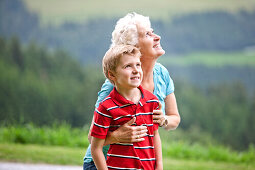 Grandmother and grandson (7 years) looking up, Styria, Austria