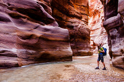 Woman hiking through a gorge, Wadi Mujib, Jordan, Middle East