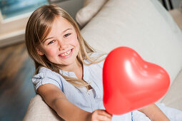 Girl holding a heart-shaped balloon, Hamburg, Germany