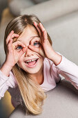 Girl circling eyes with fingers, Hamburg, Germany