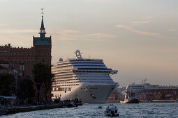Cruise ship protest, Cruise ship being towed in Giudecca Canal near Molino Stucky Hotel, Venice, Veneto, Italy