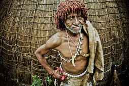 Traditional healer of a Swazi village in front of his grass hut, Swaziland, Africa