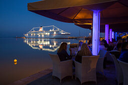 People in a restaurant in the evening with the cruise ship MS Deutschland, Reederei Peter Deilmann at the pier , Katakolon, Pyrgos, Peloponnese, Greece