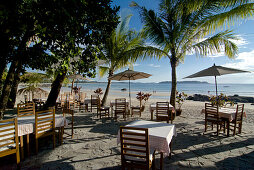 Dining tables under palm trees, Ngapali, most famous beach resort in Burma at the Bay of Bengal, Rakhaing State, Arakan, Myanmar, Burma