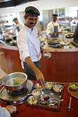 Chef showing ingredients in a hotel restaurant, Gokarna, Karnataka, India