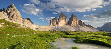 Tre Cime Di Lavaredo with reflection in a puddle, South Tyrol, Dolomites, Italy