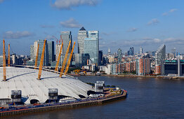 Millenium Dome and behind the skyline of the Isle of dogs and the City of London, seen from the Emirates Air Line, London, England, United Kingdom