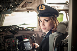 Female pilot in aeroplane cockpit