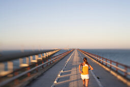 Woman Running on Bridge Over Ocean, Selective Focus, Rear View, Florida Keys, USA