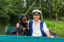 Boat tour in Spreewald, boat captain with dog, Spreewald, Spree, UNESCO biosphere reserve, Lehde, Luebbenau, Brandenburg, Germany, Europe