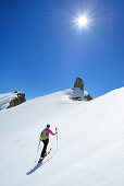 Female back-country skier ascending to Corno d Angolo, Cristallo Group, Dolomites, Veneto, Italy