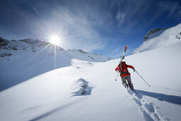 Skier ascending in deep snow, Zugspitze, Upper Bavaria, Germany