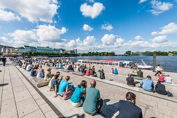 People sitting at Jungfernstieg terrace, Hamburg, Germany