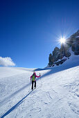 Female back-country skier ascending in Val Culea, Sella Group, Dolomites, South Tyrol, Italy