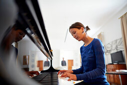 Young woman playing the piano in suite Boesendorf no.27, Altstadt Vienna Hotel, Kirchengasse 41, 7th district, Vienna, Austria