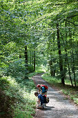 Hiker on a forest path, Bornich, Rhineland-Palatinate, Germany