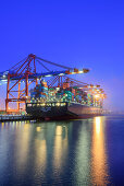 Container ships at illuminated container terminal Burchardkai at night, Waltershof, Hamburg, Germany