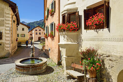 Fountain between Engadin houses, Guarda, Lower Engadin, Engadin, Canton of Graubuenden, Switzerland