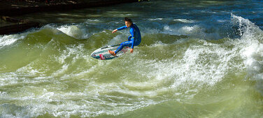 Surfer on the Eisbach river in the English Gardens, Munich, Upper Bavaria, Bavaria, Germany