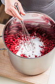 Sugar and currants in a cooking pot, making jam, Hamburg, Germany
