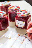 Person labeling jars of jam, Hamburg, Germany
