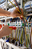 Solar park, electricans switching the wiring of the power system, Hesse, Germany, Europe