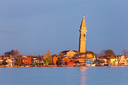 Burano Island, colourful houses, leaning campanile, tower, view from lagoon, evening sun, Venice, Italy