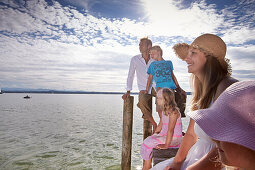 Family on a jetty at lake Starnberg, Upper Bavaria, Bavaria, Germany