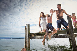 Family on a jetty at lake Starnberg, Upper Bavaria, Bavaria, Germany