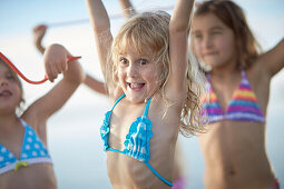 Three girls with fruitgum sticks, lake Starnberg, Upper Bavaria, Bavaria, Germany