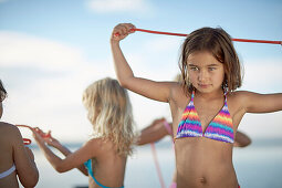 Girl with a fruitgum stick, lake Starnberg, Upper Bavaria, Bavaria, Germany